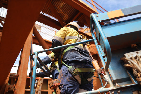 Worker On Elevating Work Platform  Wearing Fall Arrest Harness Using Locking Carabiner Which Attached With Energy Shock Absorber Lanyard Safety Device Clipping Into Anchorage Inside Of The Basket  