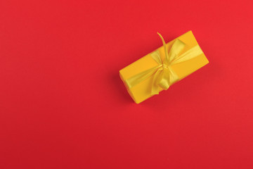 Gift box with ribbon and bow on color background and space for text. Top view - Image