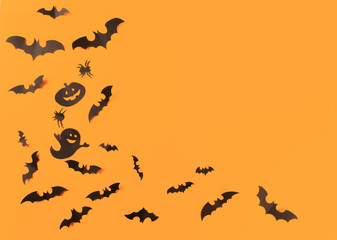 Halloween paper decorations on orange background. Halloween concept. Flat lay, top view, copy space - Image
