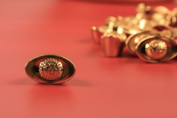 Golden chinese traditional money on red color background. Representing rich, wellness, properity, lucky, happiness for Chinese New Year celebration