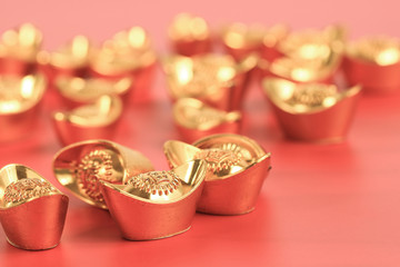 Golden chinese traditional money on red color background. Representing rich, wellness, properity, lucky, happiness for Chinese New Year celebration