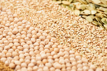 close up view of dry chickpea, raw buckwheat and pumpkin seeds