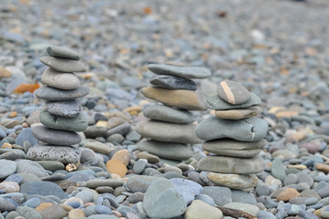 Fototapeta na wymiar Stony beach in Ireland with grey pebbles tower Zen and balance Concepts: stone, tranquil, relax, balance, stability