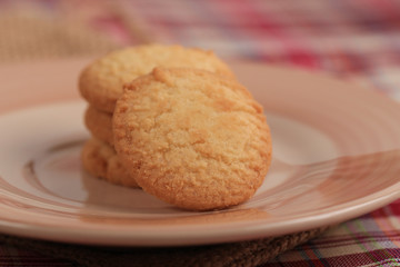 Round sweet cookies. Delicious dessert with high sugar and carbohydrate suitable for eating with milk and tea or coffee on color and white background with colorful placemat