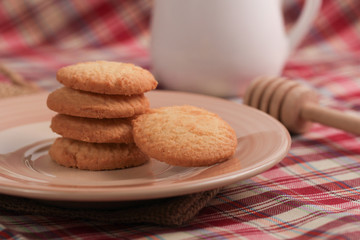 Round sweet cookies. Delicious dessert with high sugar and carbohydrate suitable for eating with milk and tea or coffee on color and white background with colorful placemat