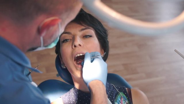 dentist repairing a tooth with a girl in a hospital