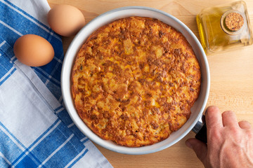Close-up of homemade (Spanish) potato omelette with natural ingredients (fresh eggs, olive oil, potatoes, onion, chorizo)