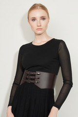 Cropped front view shot of a blond girl, wearing black dress with transparent sleeves and dark...