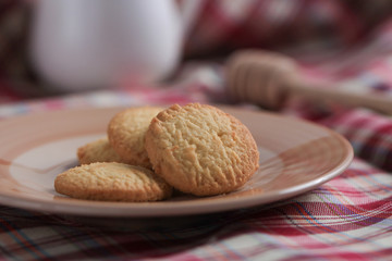 Round sweet cookies. Delicious dessert with high sugar and carbohydrate suitable for eating with milk and tea or coffee on color and white background with colorful placemat