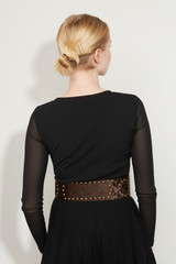 Cropped back view shot of a blond girl, posing on a white background. She is wearing black gown...