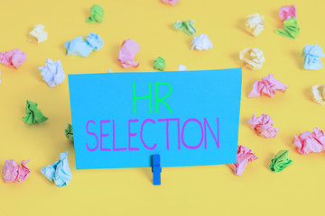 Writing note showing Hr Selection. Business concept for Process and approached by huanalysis resources when hiring employees Colored crumpled paper empty reminder white floor clothespin