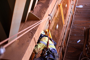 Rope tension tie line with defocused rope access technician working at the back background...