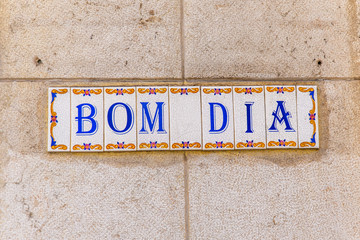 Bom Dia Good Morning tiles or azulejo on a building in Lisbon.