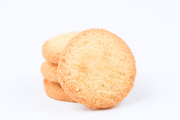 Round sweet cookies. Delicious dessert with high sugar and carbohydrate suitable for eating with milk and tea or coffee on color and white background with colorful placemat