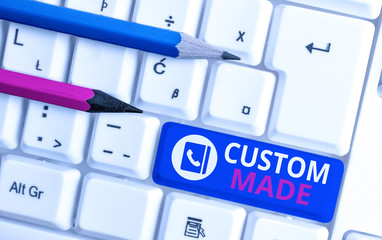 Writing note showing Custom Made. Business concept for something is done to order for particular customer organization White pc keyboard with note paper above the white background
