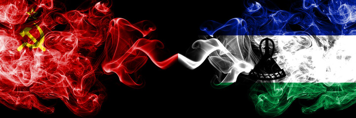 Communist vs Lesotho abstract smoky mystic flags placed side by side. Thick colored silky smoke flags of Communism and Lesotho