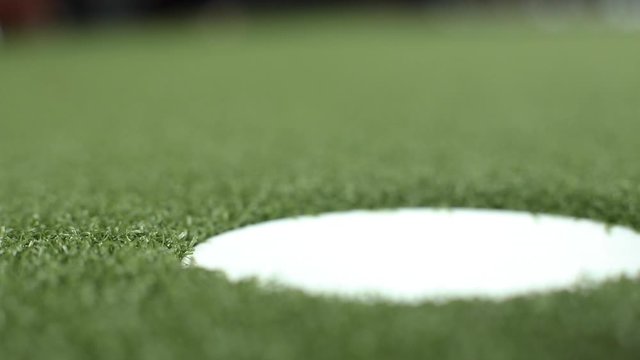 Close-up Putting Small Golf Ball Into Hole High Angle. Golfer Enjoying Playing Professional Sport Golfing Surrounded By Green Grass Field View From Above