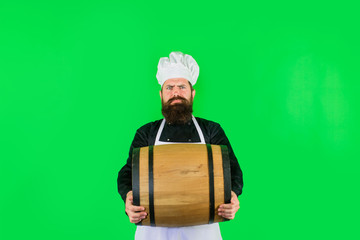 Homemade wine. Wooden barrel of beer. Beer in Germany. Barman. Equipment for preparate of beer. Brewery for maturing alcohol. Bearded cook with wooden barrel of beer. Celebration oktoberfest festival.