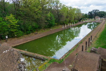 Fototapeta premium Ancient Pool Canopus, surrounded by greek sculptures in Hadrian's Villa (Villa Adriana, 2nd century AD), Tivoli, Italy, UNESCO World Heritage Site