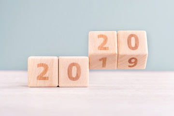 Abstract 2020 & 2019 New year countdown design concept - wood blocks cubes on wooden table and low...