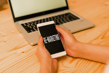 Handwriting text Re Marketing. Conceptual photo Strategy to reach potential customers in your website woman laptop computer smartphone mug office supplies technological devices