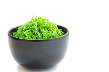 Hiyashi Wakame Chuka or seaweed salad in black bowl on white background ,Japanese food
