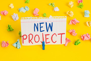 Word writing text New Project. Business photo showcasing individual enterprise that is planned to achieve particular aim Colored crumpled papers empty reminder white floor background clothespin