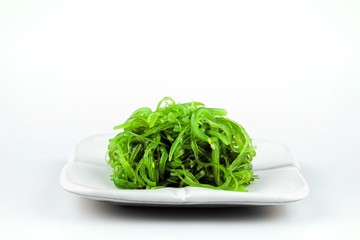 Hiyashi Wakame Chuka or seaweed salad in white bowl  on white background, Japanese food