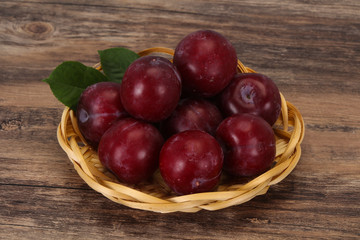 Plum heap in the wooden basket