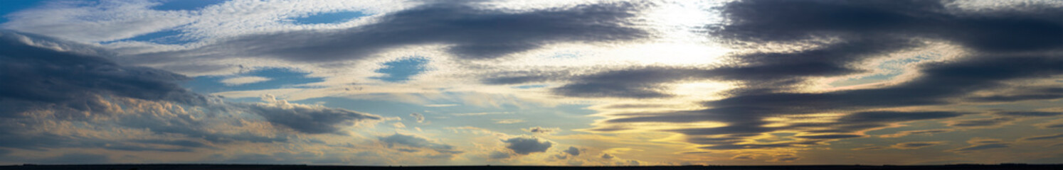 Leaden, storm clouds covered the sunset. Cumuliform cloudscape on blue sky. The terrain in southern Europe. Fantastic skies on the planet earth. Tragic gloomy sky.