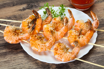 Grilled prawn skewer with sauce