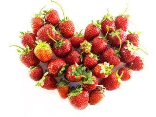 Strawberries with leaves. Red heart. Symbol of love. St. Valentine's Day. Harvest. Ripe berries. Dessert. Color photo