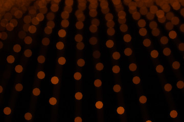 abstract orange illumination from unfocused garland decor object winter holidays dark background concept picture 