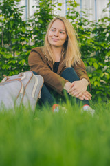 Hipster young woman in park with a backpack