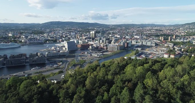 Cinema 4K drone shot with forward reveal motion and panorama view of the Oslo city line and construction in Bjoervika, a tourist attraction with the Munch museum, Soerenga and Barcode, in Norway.