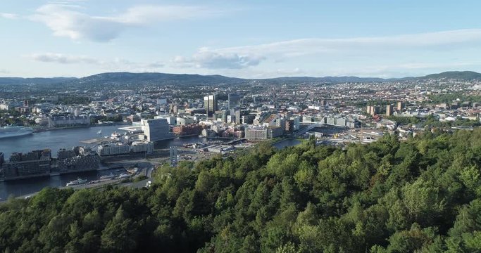 Cinema 4K drone shot with backward reveal motion and panorama view of the Oslo city line and construction in Bjoervika, a tourist attraction with the Munch museum, Soerenga and Barcode, in Norway.