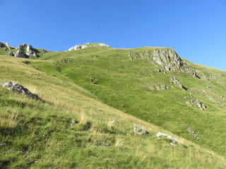 Fototapeta na wymiar Mountain landscape slopes and elevations with vegetation