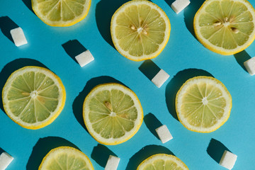 Lemon slices and sugar cubes on a blue background