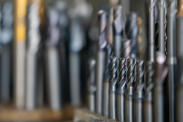 The various type  cutting tools of CNC machine on the stock shelf  in the light blue scene. The...