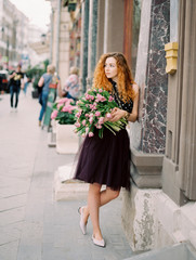 young beauty woman with flower buquet on the spring street. film analog photography