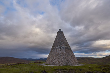 The Maule Monument on top of the Hill of Rowan, deep in the Angus Glens of Scotland on a Septembers evening with dramatic Clouds above.