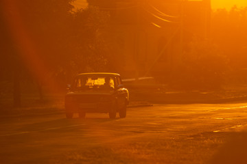Obraz premium old soviet car is driving down the road