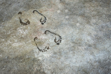 wet human footprints on the stone