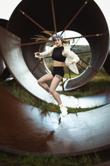 Urban hip hop style dancer practicing dance moves in industrial zone.