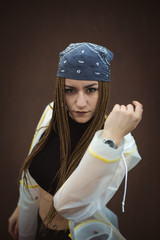 Urban hip hop style dancer practicing dance moves in industrial zone.