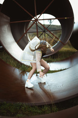 Urban hip hop style dancer practicing dance moves in industrial zone.