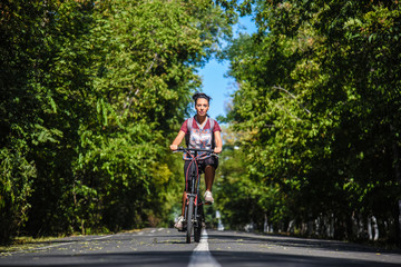 Obraz premium Girl rides on a walking bike