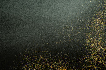 Golden sparkles on black background. Festive concept. - Image