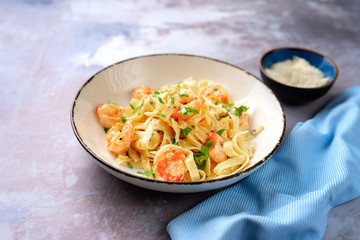 Tasty creamy shrimp fettuccine alfredo with parmesan