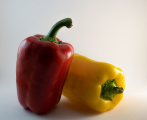 Two isolated sweet and spicy bell peppers on the bright background